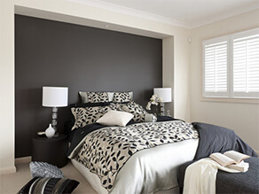 Luxurious Black and White Bedroom with a Matt Black Feature Wall and Black and White Bed Covers
